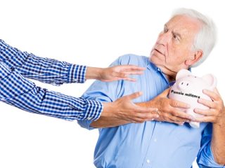 Senior man protecting piggy bank, savings from being stolen