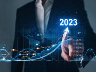 Businessman draws increase arrow graph corporate future growth year 2022 to 2023. Planning,opportunity, challenge and business strategy. New Goals, Plans and Visions for Next Year 2023